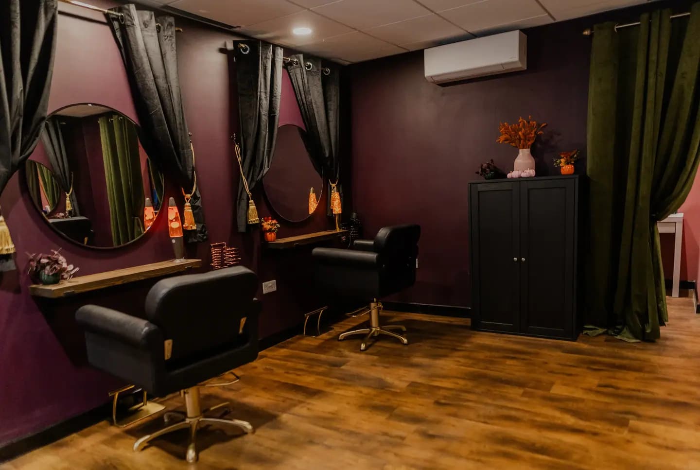 The salon's working floor: styling chairs and round mirrors along the wall