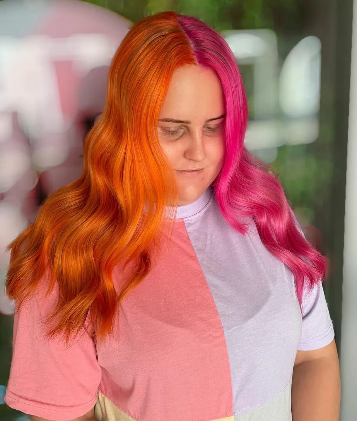 Split dye: hot pink and copper orange divided down the parting